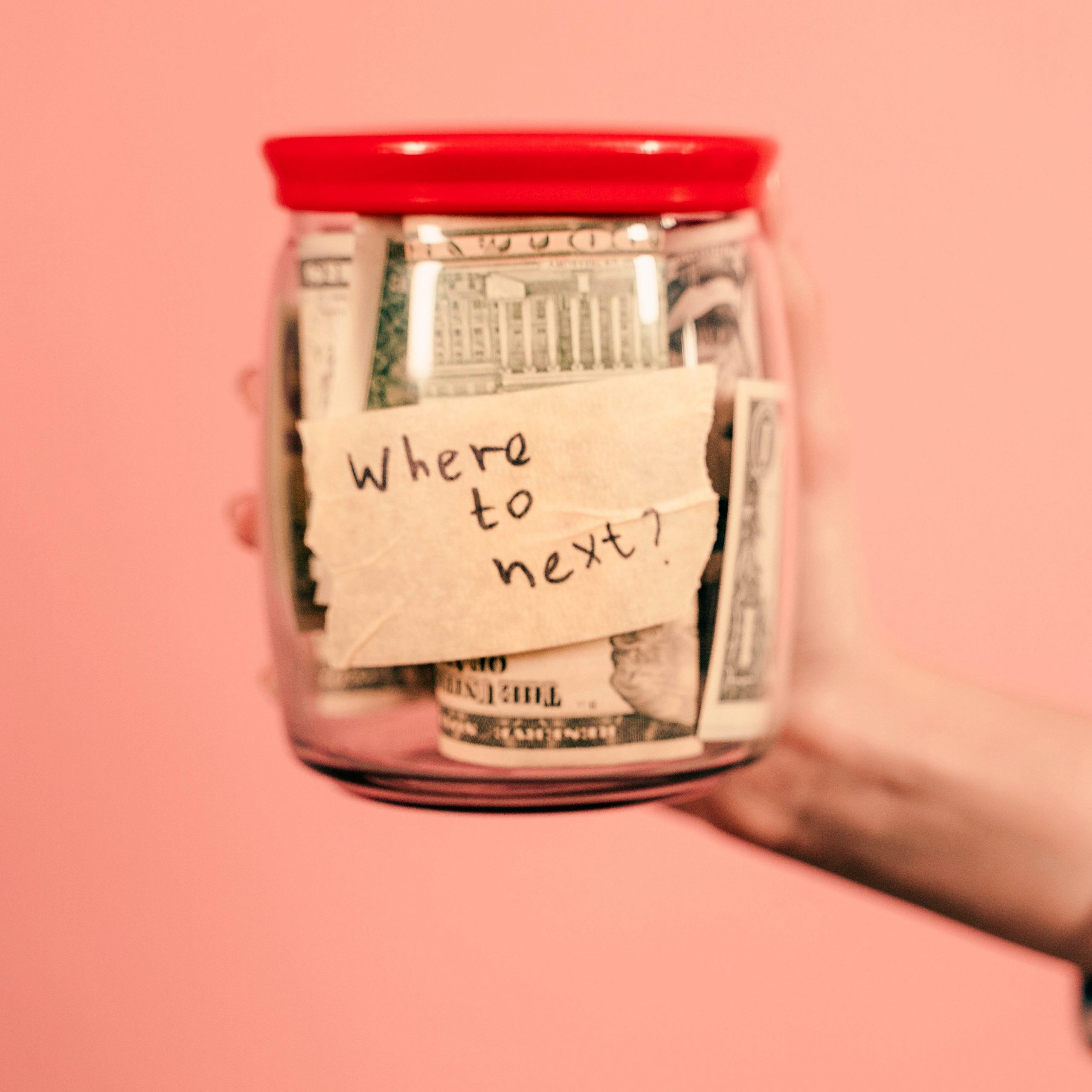 Money jar on pink background