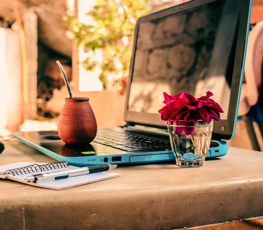 Laptop and Supplies onf Table