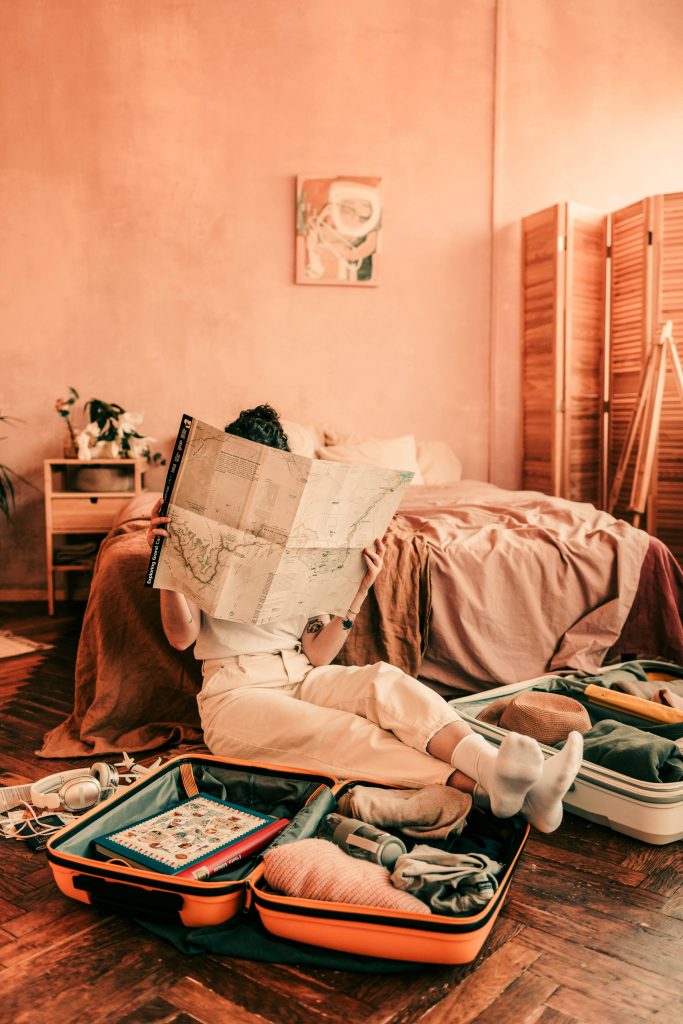 Woman with Map and Suitcases