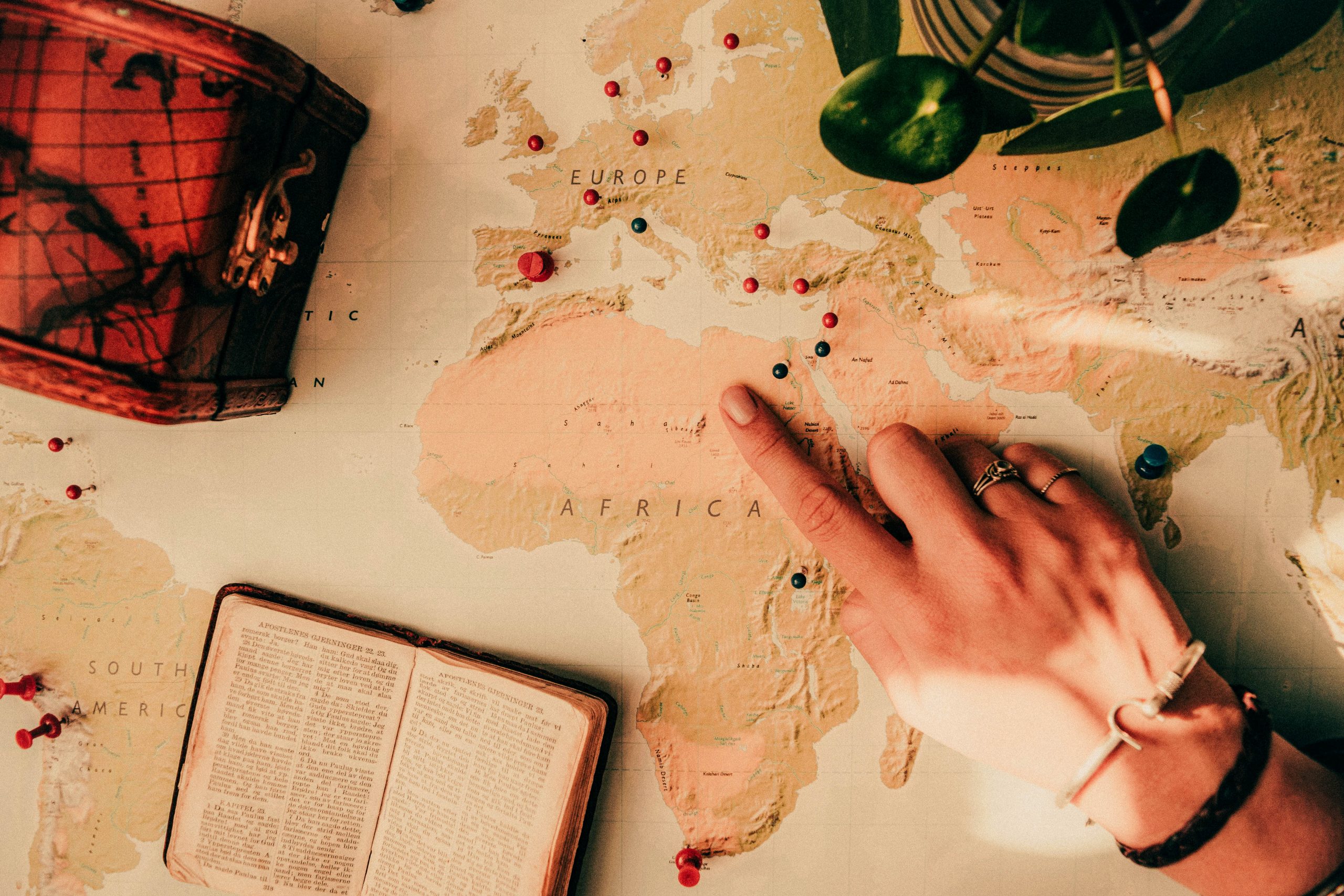 Woman's hand pointing on a map