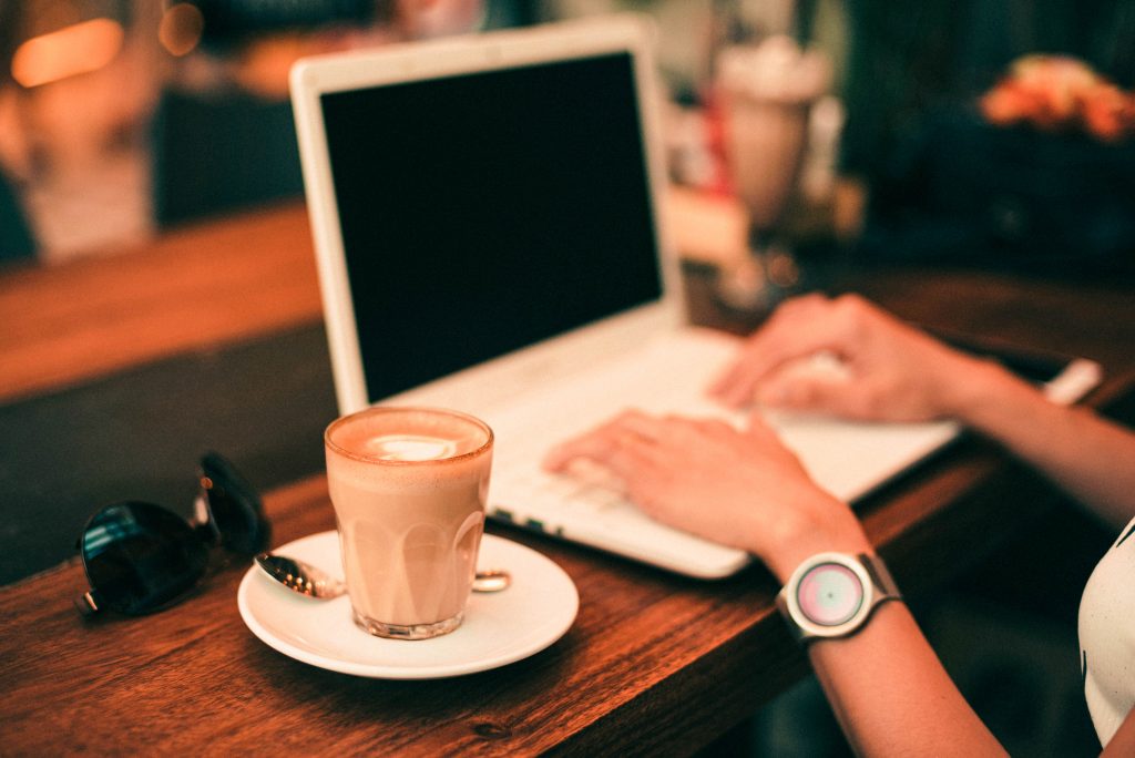 person working on laptop with coffee