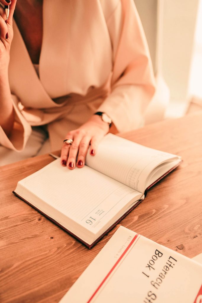 woman writing in book