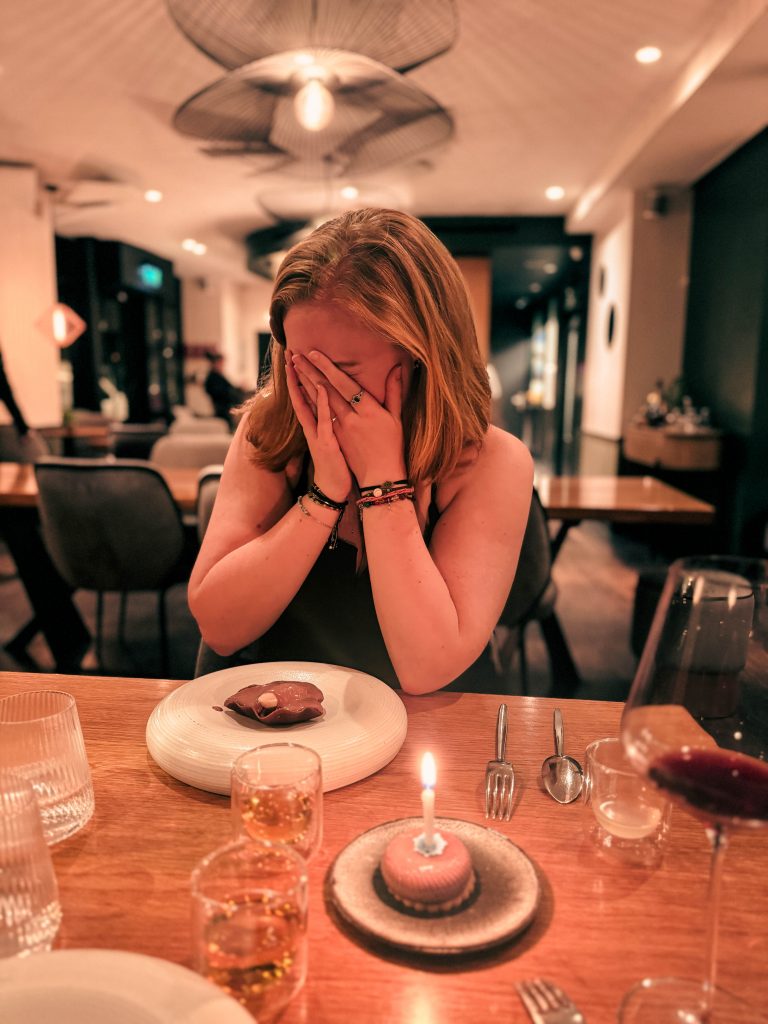 photo of elle hiding her face at her birthday dinner