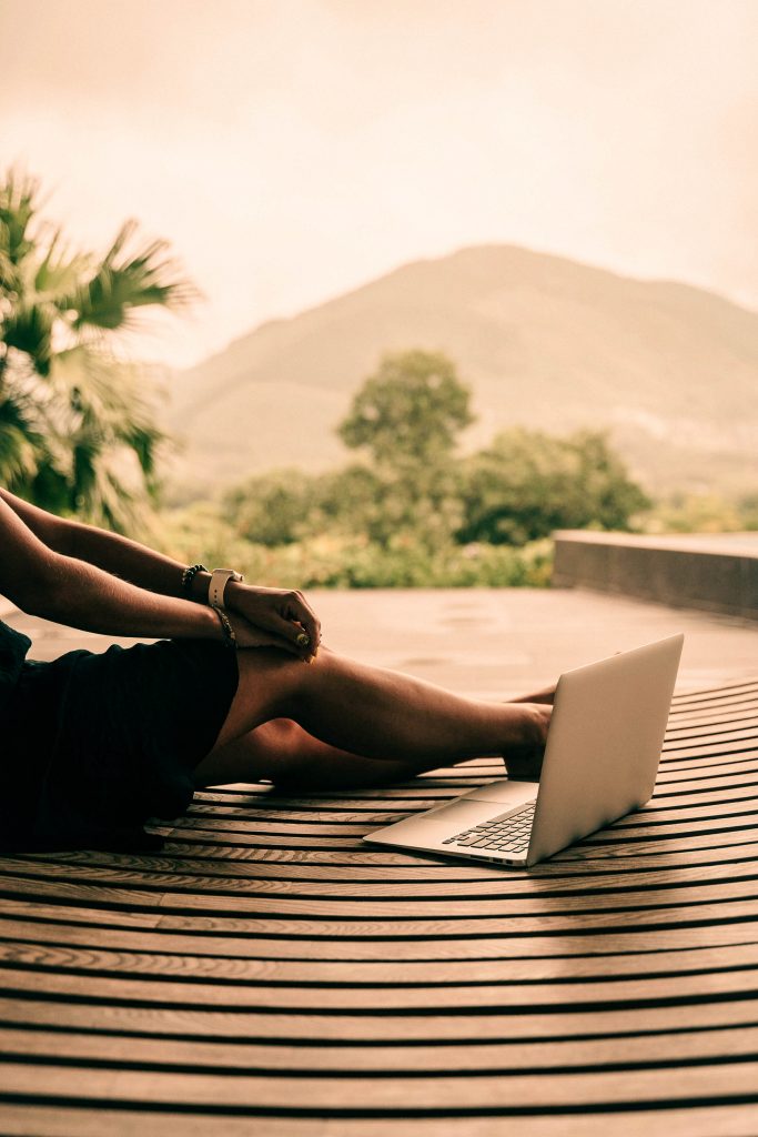 person on a laptop sitting outdoors