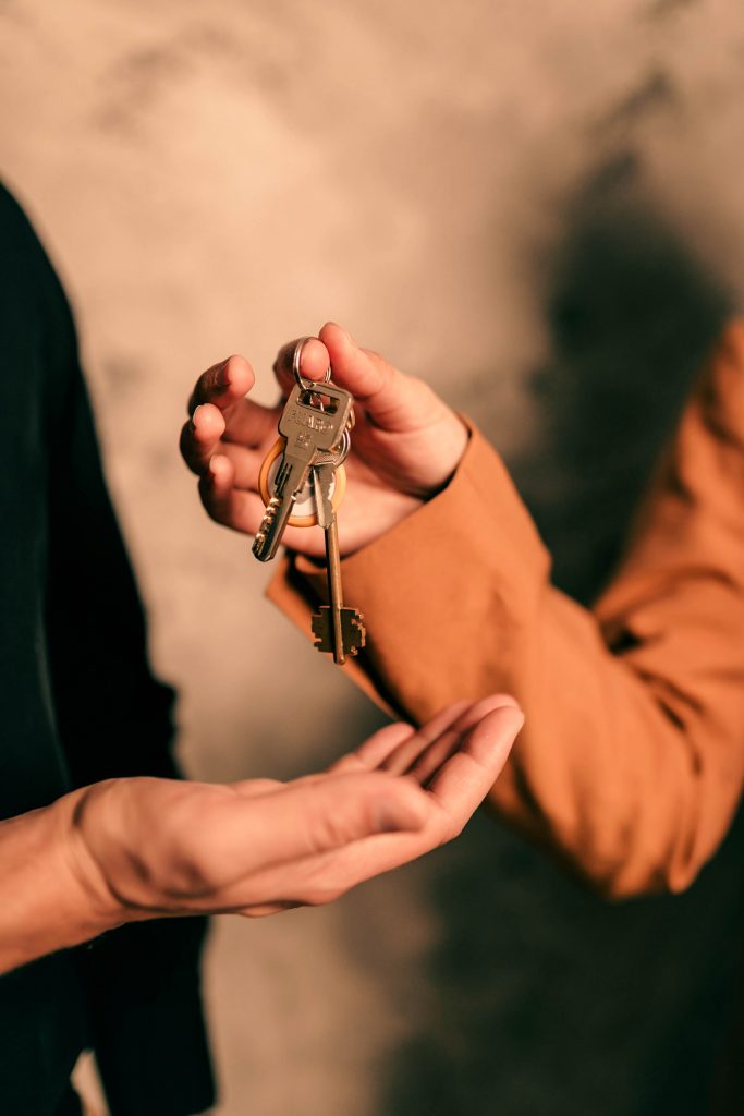 person handing off keys
