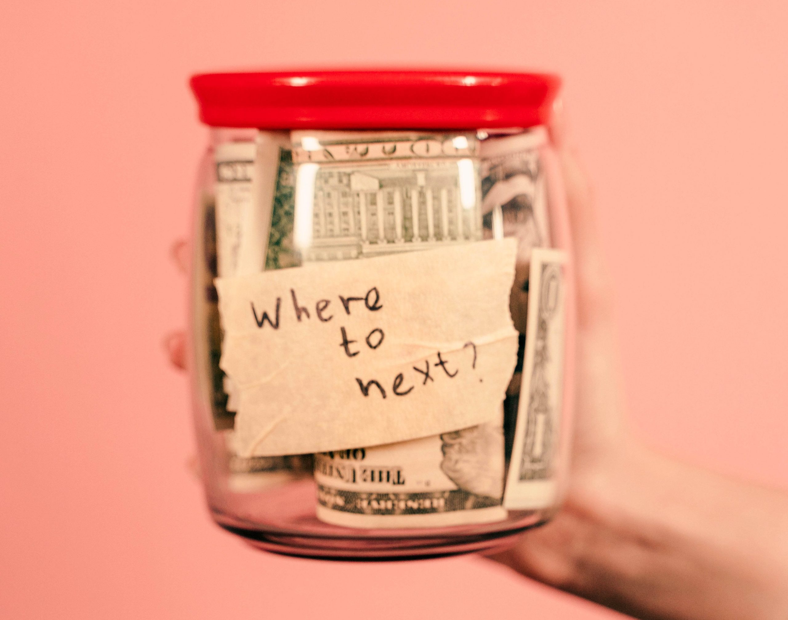 Money jar on pink background