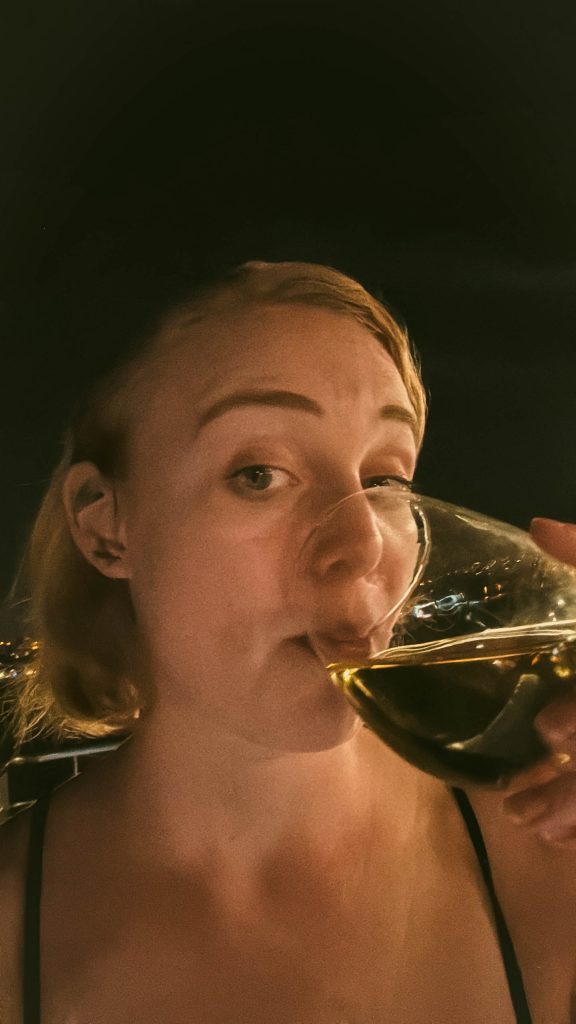 Elle with a glass of wine